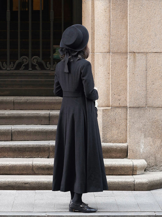 Moonland Modern Redingote coat back view, pleated skirt with defined waist and center vent, full length double-faced black cashmere coat