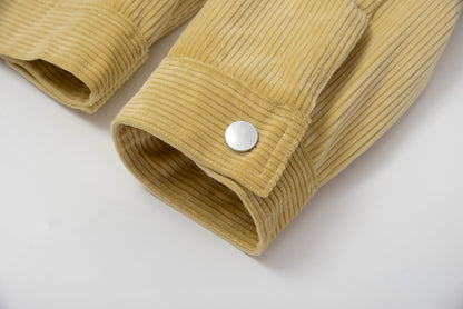 Close-up of a mustard yellow corduroy jacket with a button on a light gray background #color_creamy-yellow
