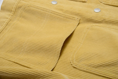 Close-up of a mustard yellow corduroy fabric with button details #color_creamy-yellow