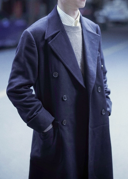 Front view of model wearing Moonland's dark blue polo coat for men outdoors. fabric from Loro Piana cashmere