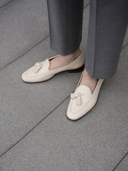 Moonland Ivy grey wool trousers, straight leg with sharp front crease and clean ankle length hem, styled with cream tassel loafers.