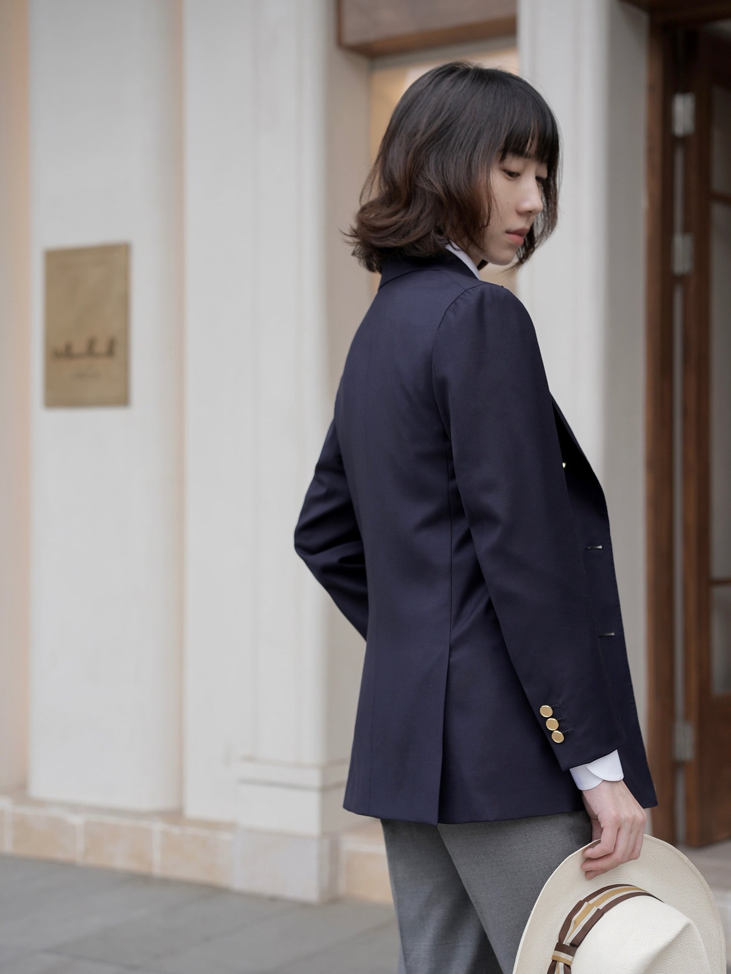 Moonland Ivy double breasted navy wool blazer, side back view, twin vents at the back, 3 button cuffs, business casual styling