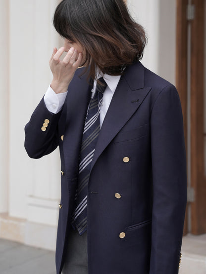 Moonland Ivy double breasted navy wool blazer, frongt detail, wide and sharp peak lapels and gold buttons, hand finished buttonholes and edges, reinforced jetted pockets.