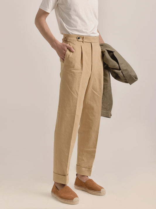 Side-front view of model in Moonland Ivy Chinos in beige Roger Laviale cotton twill, showing slanted pocket, side adjuster, and straight leg fit.