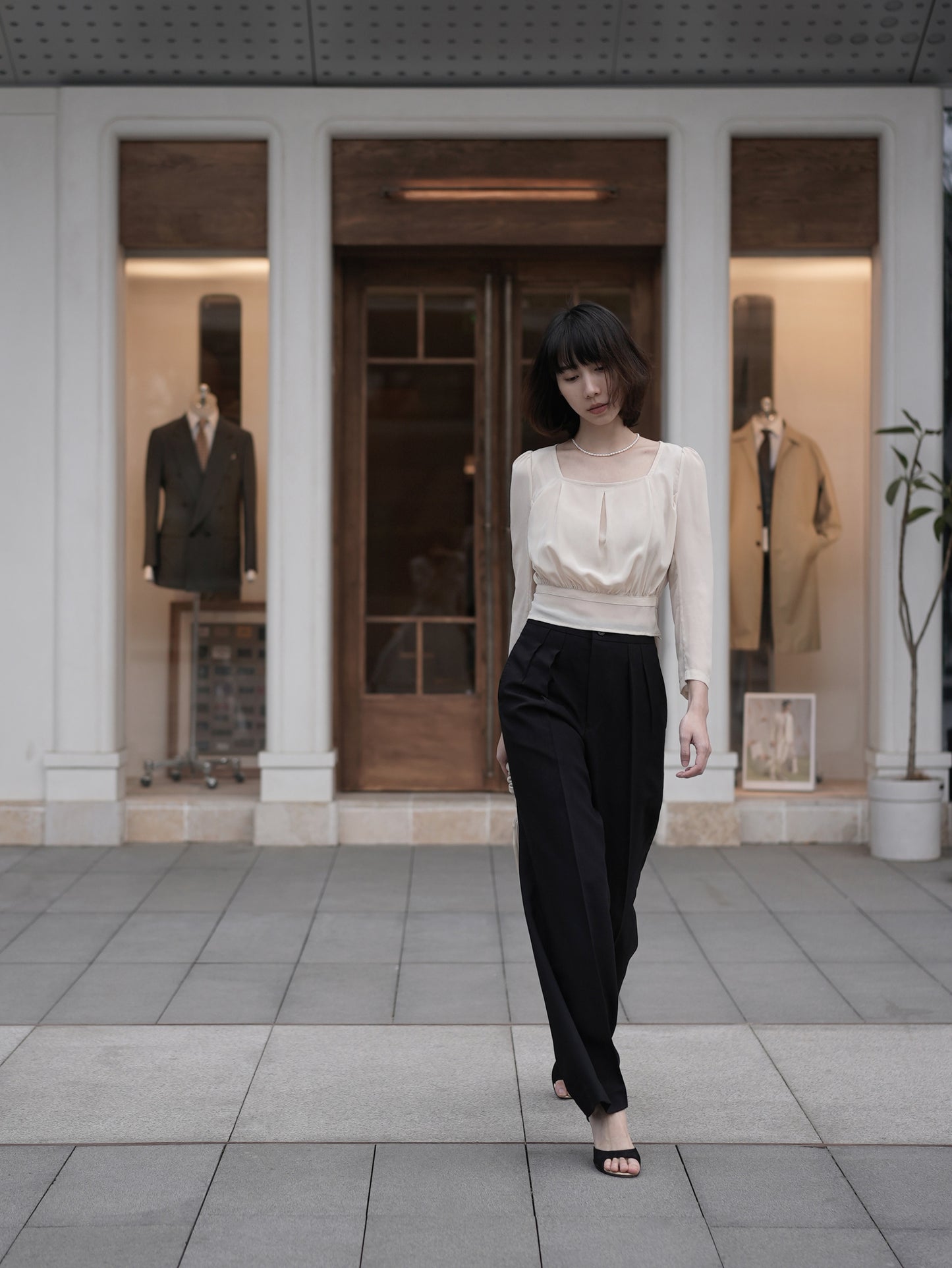 Moonland Monday worsted wool trousers in black, high-rise waist, straight cut with central pleat turning into a sharp crease.