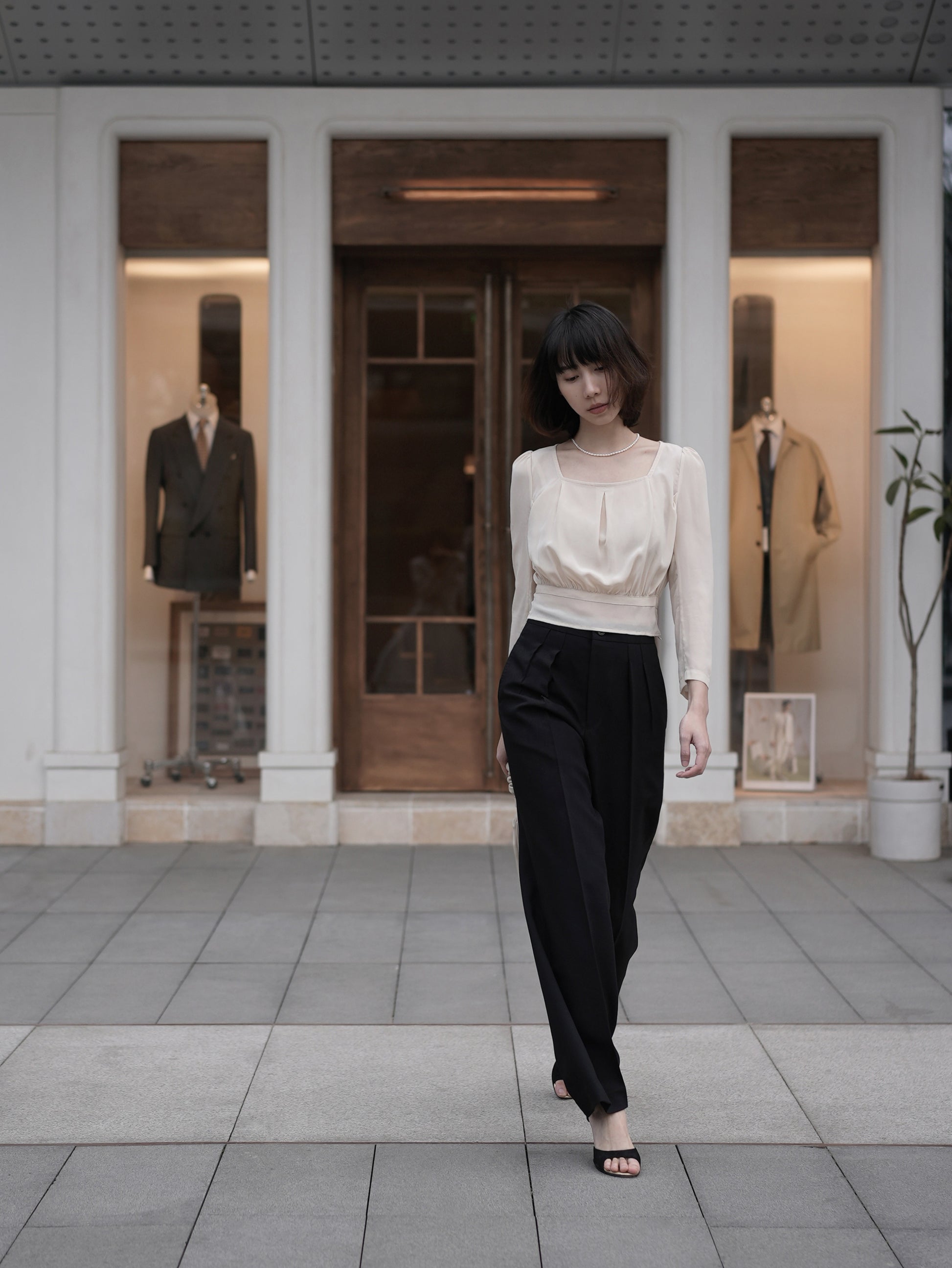 Moonland Monday worsted wool trousers in black, high-rise waist, straight cut with central pleat turning into a sharp crease.