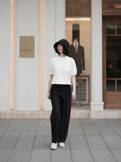 Moonland Monday worsted wool trousers in black, high-rise waist, straight cut with central pleat turning into a sharp crease, casually pairing with a t-shirt and sneakers