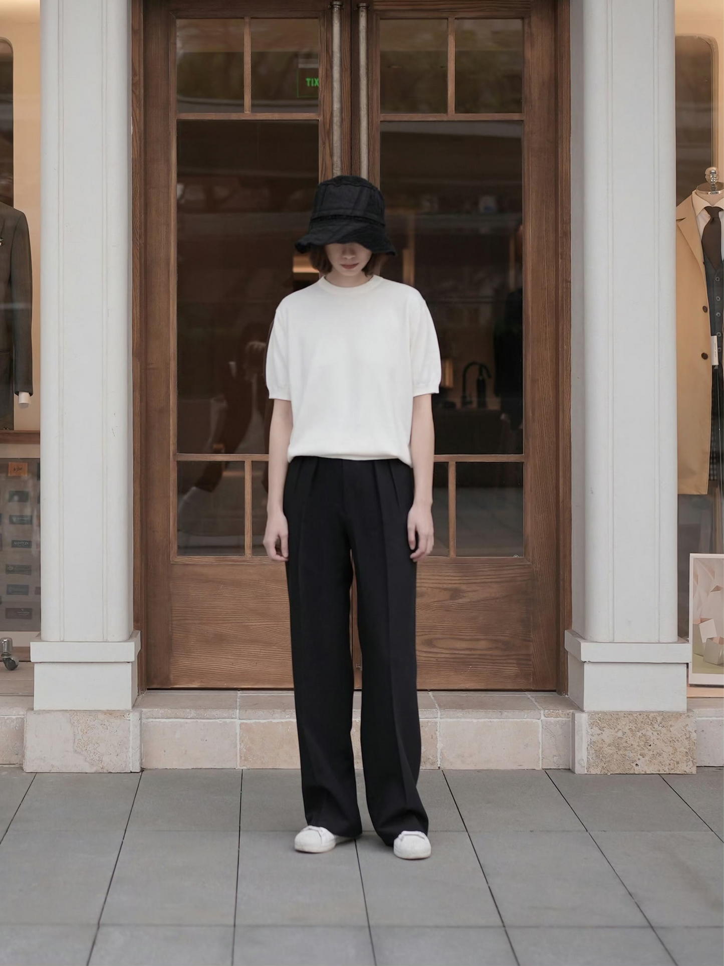 Moonland Monday worsted wool trousers in black, high-rise waist, straight cut with central pleat turning into a sharp crease, casually pairing with a t-shirt and sneakers