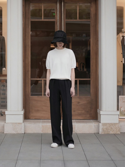 Moonland Monday worsted wool trousers in black, high-rise waist, straight cut with central pleat turning into a sharp crease, casually pairing with a t-shirt and sneakers