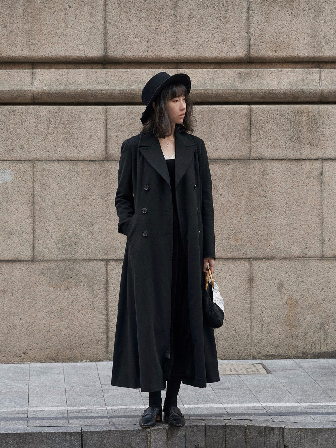 Moonland Modern Redingote coat front view, double breasted with peak lapels, full length fit and flare, double-faced black cashmere coat