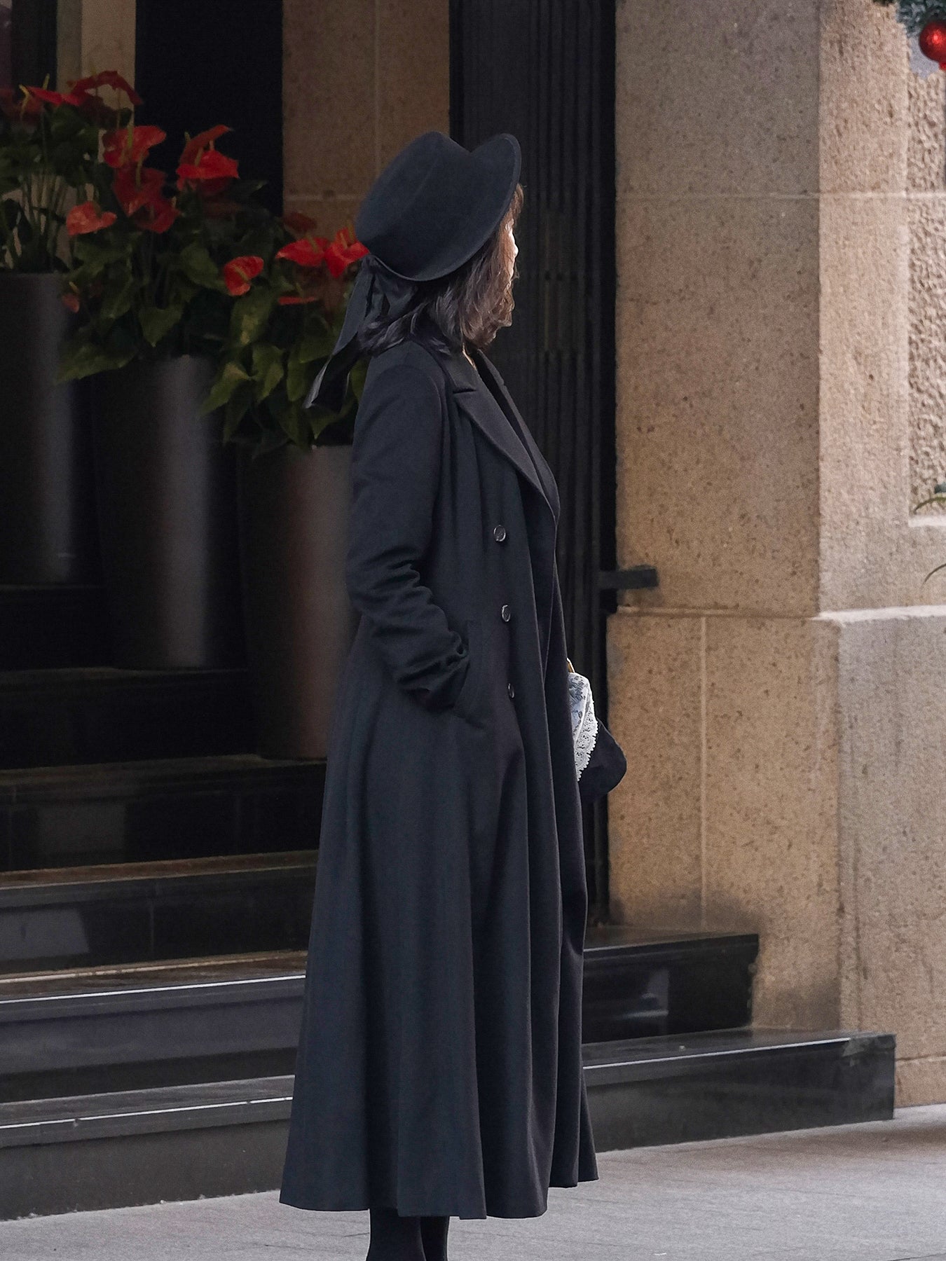 Moonland Modern Redingote Coat Side view showing princess seams and sculpted waist and side welt pockets, flowing full length classic double-faced black cashmere coat