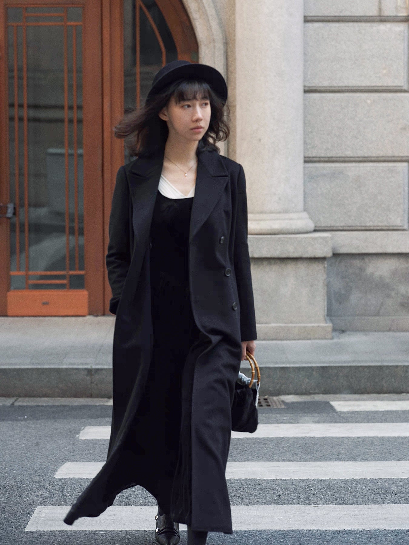 Moonland Modern Redingote coat front view, double breasted with peak lapels, full length fit and flare, double-faced black cashmere coat