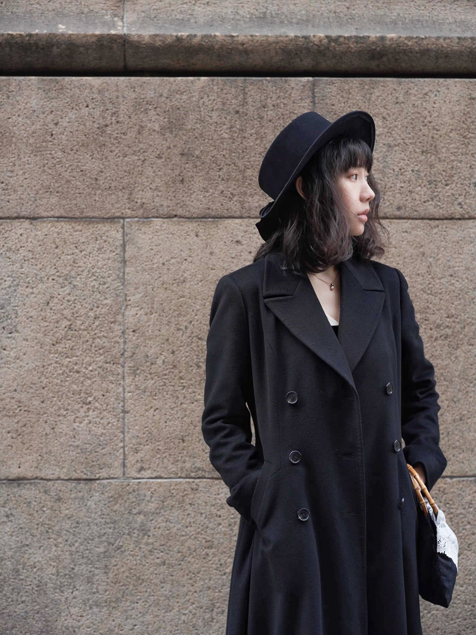 Moonland Modern Redingote coat front view, double breasted with peak lapels, full length fit and flare, double-faced black cashmere coat