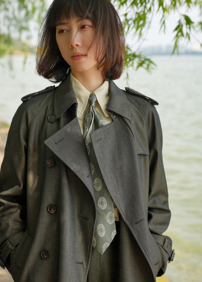 Moonland dark green trench coat with detachable down layer, close chest view, double breasted with epaulettes and sleeve straps, refined buttons and stitching #color_cypress-green
