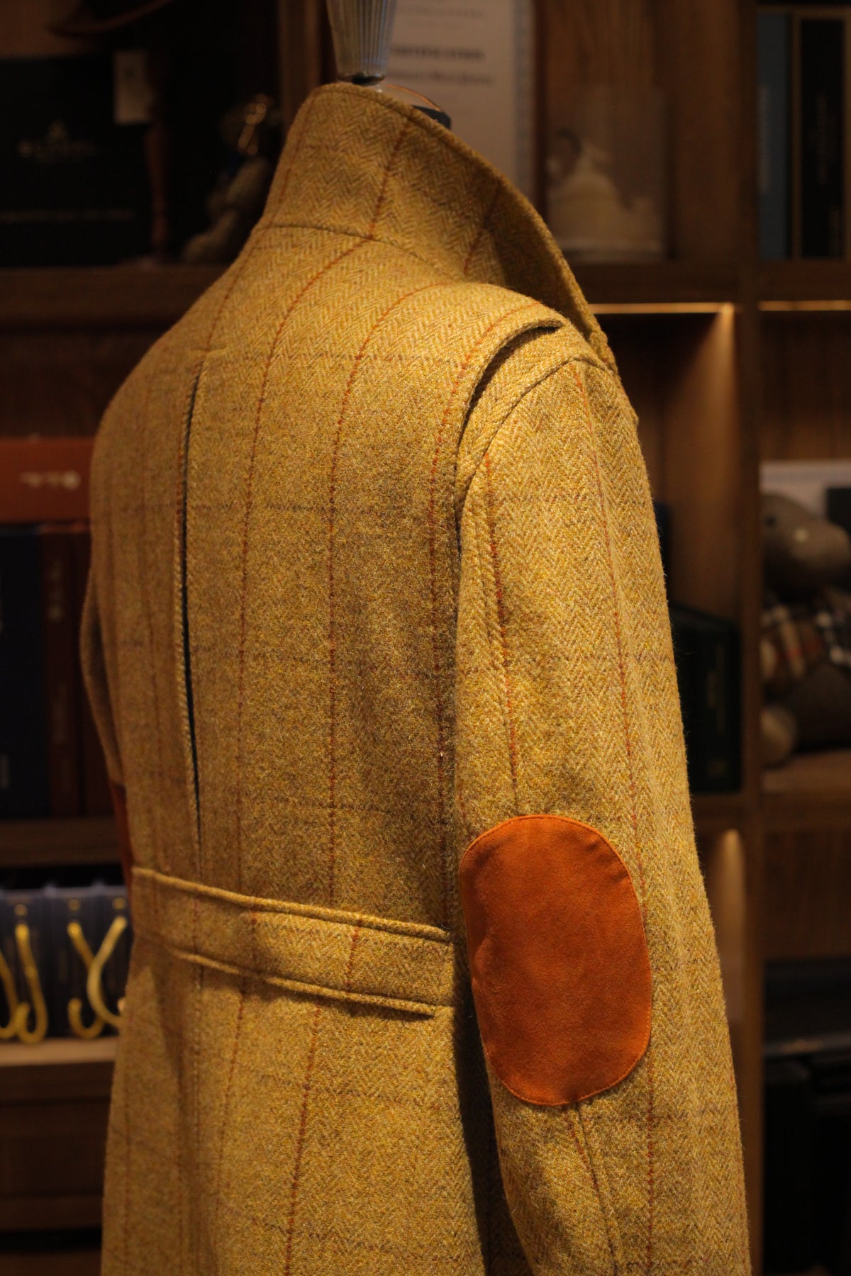 Urban Alpine Jacket in ochre Harris Tweed, back three-quarter view with suede elbow patch