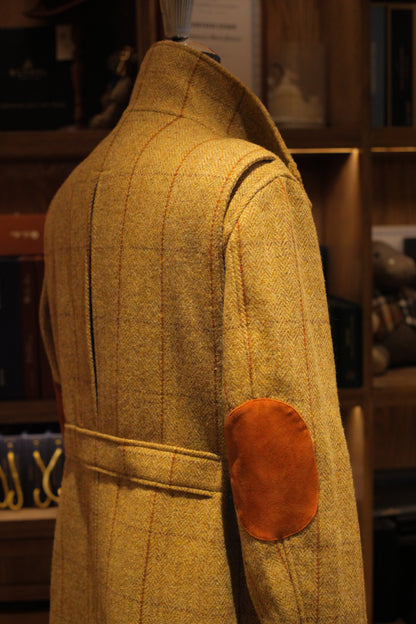 Urban Alpine Jacket in ochre Harris Tweed, back three-quarter view with suede elbow patch